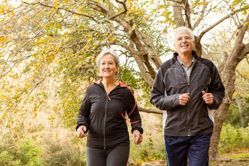Senior couple walking for fitness in the park