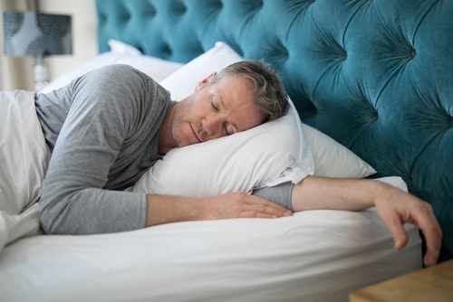Man sleeping soundly in bed