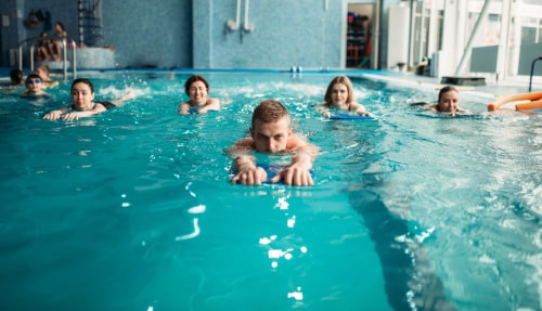 Group swimming in a pool for exercise