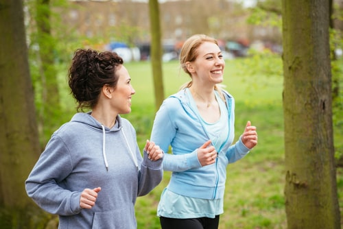 Happy women walking together in park