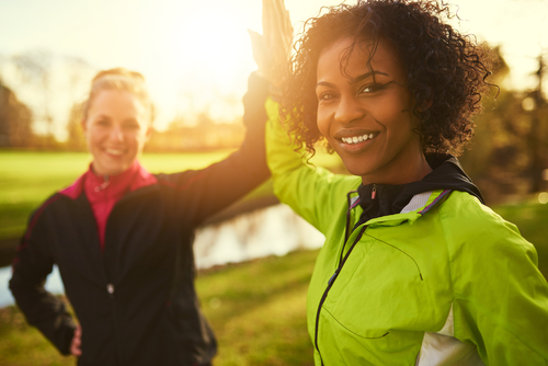 Women high-fiving after exercise