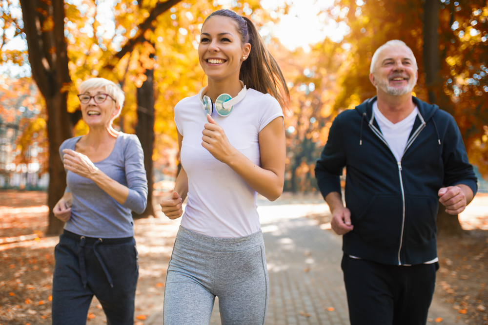 Different generations walking for fitness together in park