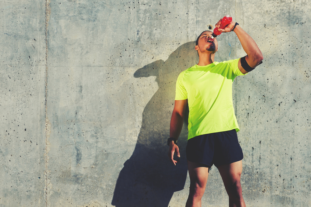 Athlete drinking a sports drink after a run
