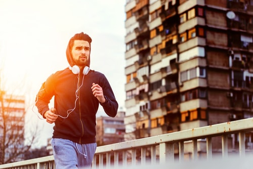 Man doing jog or intense fitness walk in city