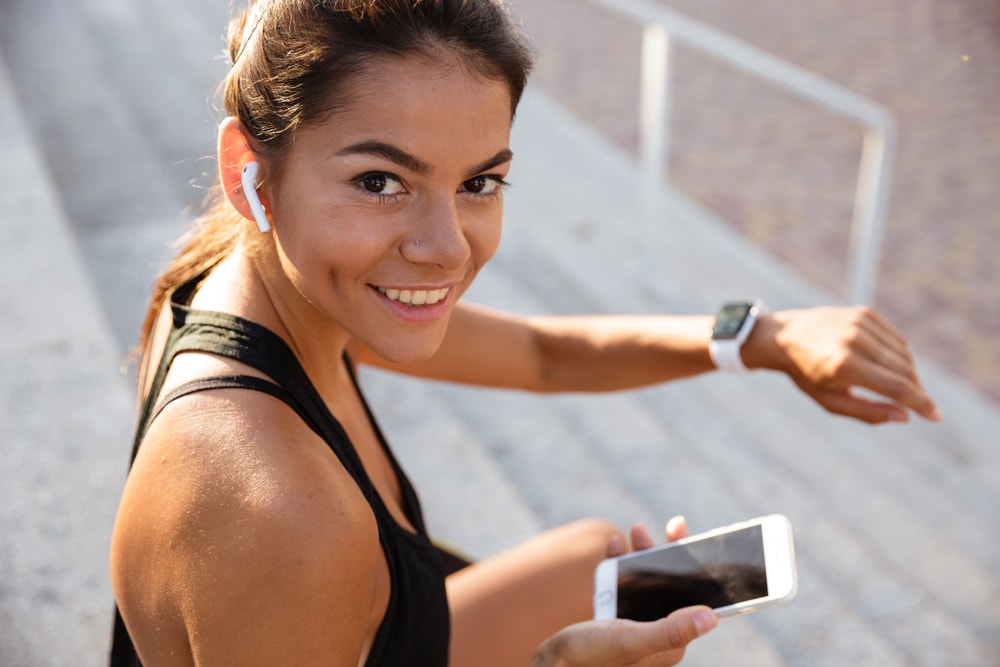 Athletic woman checking her phone during exercise