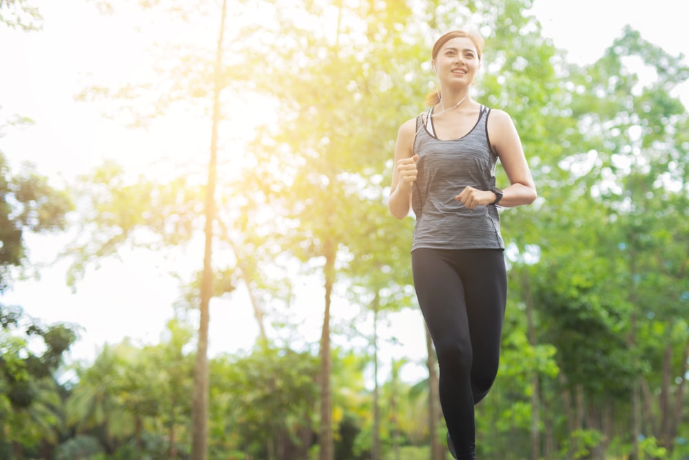 Woman doing walk or run in a green park